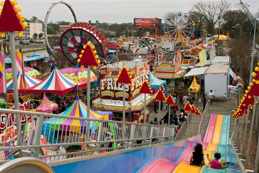 Atlanta, GA, USA - March 15, 2014:  High-angle view of carnival rides and tents packed into tight space at the annual Atlanta Fair. 