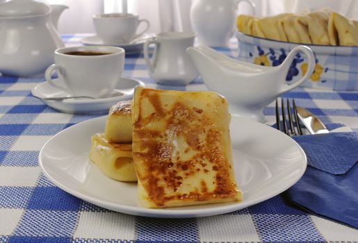 Spring rolls and a cup of coffee on the table