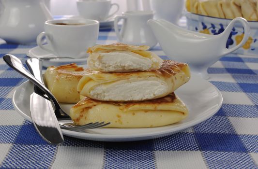 Spring rolls and a cup of coffee on the table