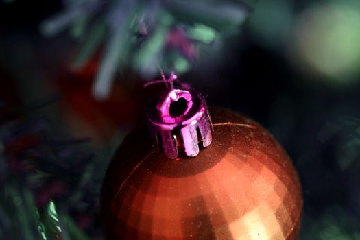 Close up of Christmas ornaments on tree.