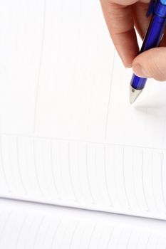 Close-up of woman hand writing in agenda