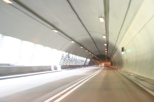 Car lights trails in a tunnel