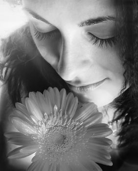 Macro image of a girl face with a red flower