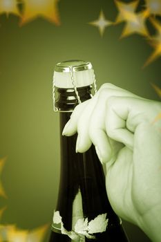 Woman hands opening champagne bottle