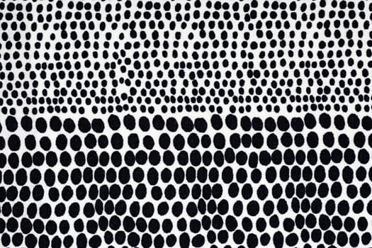 White fabric with black dots, a background or texture