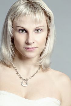 studio portrait of beautiful woman with white dress 