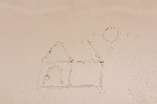 Painting a house on sand background with the sun