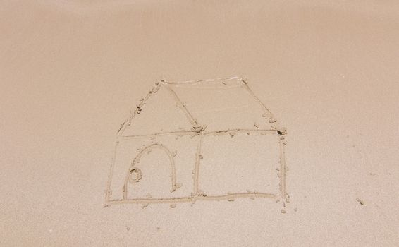 Painting a house on sand background