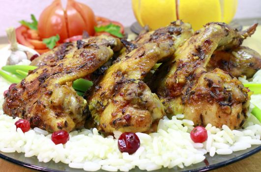 Fried chicken wings with rice and cranberries