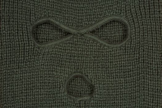 Green abstract background or texture, a balaclava mask.