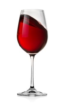 Waving red wine in a glass isolated on a white background