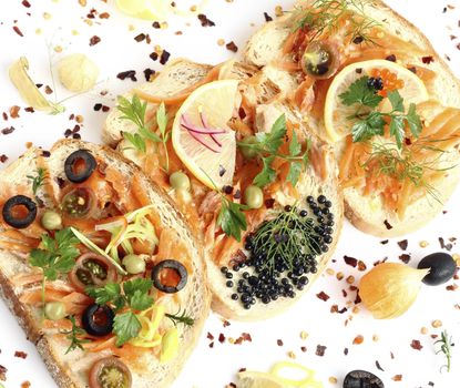 close up appetizing sandwiches with smoked salmon and vegetables