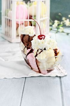 Banana split with neapolitan ice cream, whipped cream and cherry.