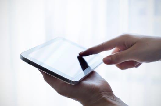 Woman hand working with tablet and pointing touchscreen