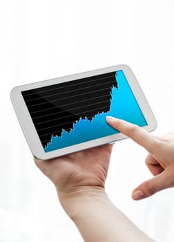 Woman pointing tablet with growing chart on screen