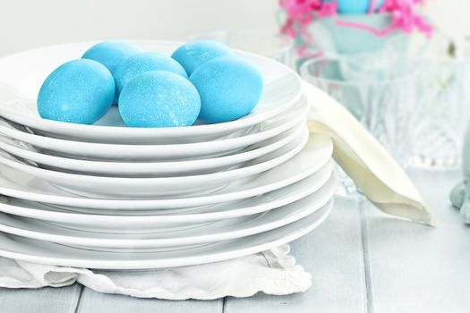 Blue dyed eggs with plates for Easte. Shallow depth of field.