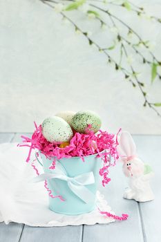 Easter eggs in a blue tin bucket. Shallow depth of field.