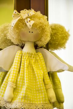 doll angell with wings in beautiful yellow dress