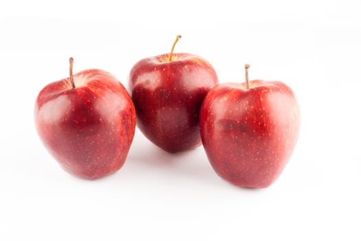 three red ripe fresh apples on white