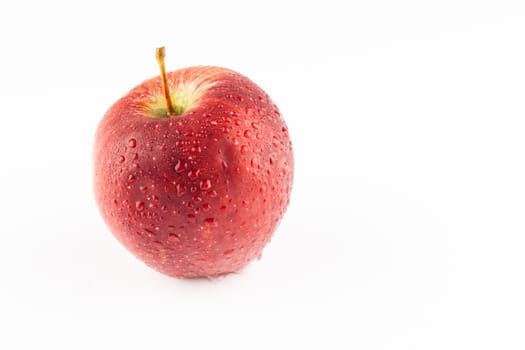 Fresh red apple whit waterdrops on white background