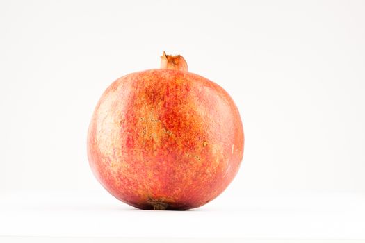 big ripe red pomegranate on white background
