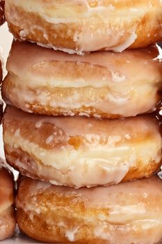 Stacked of delicious glazed donuts.