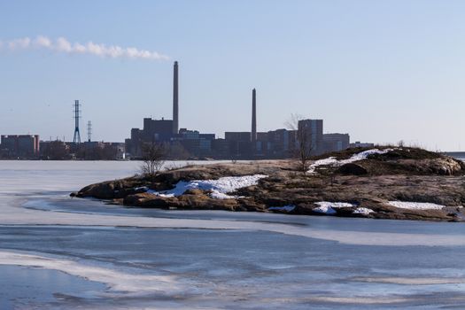 Industrial landscape over a rocky ocean shore