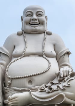 At the Vinh Tranh Pagoda in My Tho, the Mekong Delta, stands this huge statue of the smiling Buddha. Here, the person is isolated and fills the entire picture.