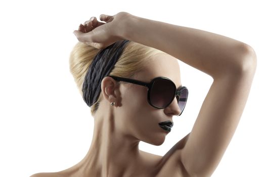 fashion portrait of young blond woman with hair style black lips and wearing sunglasses posing against white background