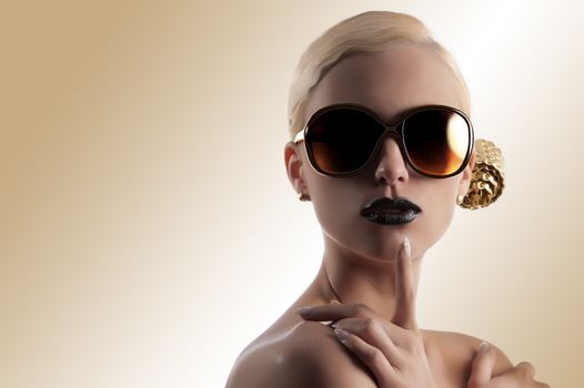 fashion portrait of young blond woman with hair style black lips and wearing sunglasses over white