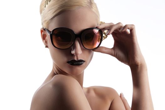 fashion portrait of young blond woman with hair style black lips and wearing gold sunglasses over white