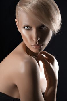 beauty portrait of a blonde girl showing her nude shoulder