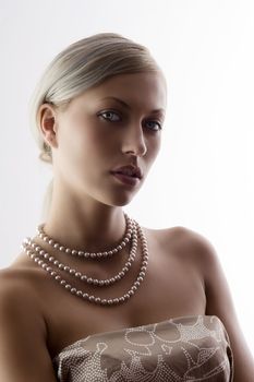 pretty and elegant blond woman with pearl necklace