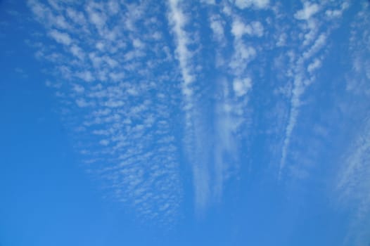 Fleecy clouds in blue sky