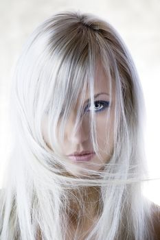 fashion portrait with forced and light color of pretty blond girl with long hair