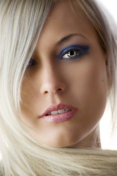 very nice portrait of blond graceful girl with blue make up