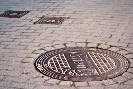 Cover the wells on the pavement in the old town of Stockholm