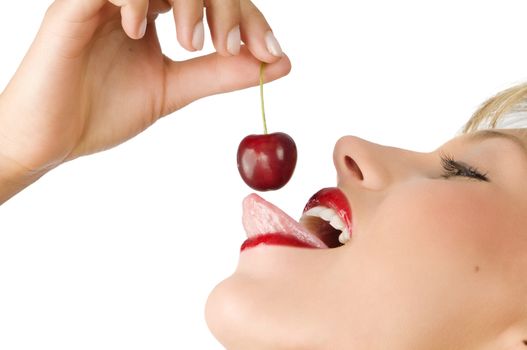 close up on of a sensual girl playing with her tongue with a cherry
