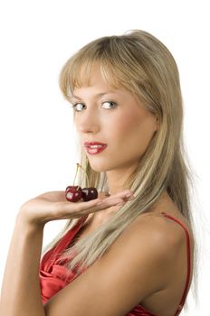 blond sensual girl with red lips and red dress keeping cherries in her hand