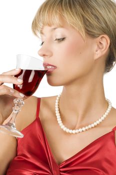 close up of an elegant blond girl with necklace drinking red wine