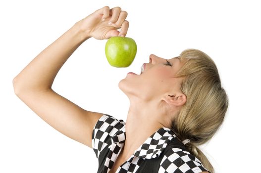 nice young girl trying to bite a green apple