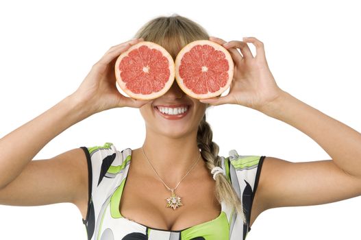 beautiful blond girl with green dress using grapefruit as glasses
