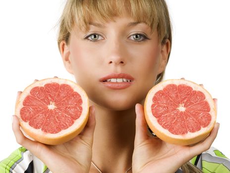 close up of blond girl with two half grapefruit in her hands