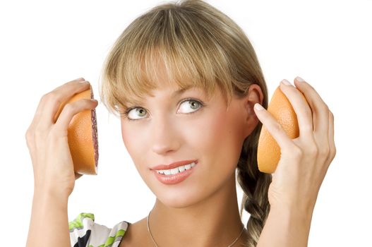nice girl playing with half grapefruit as they are headphone
