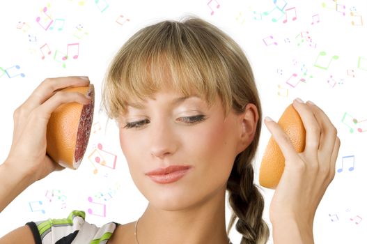 nice girl listening music with two half grapefruit as they would be headphone