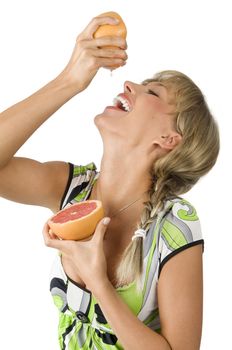 fresh portrait of a girl laughing and drinking juice from squeezed grapefruit