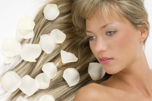 close up of a nice girl with laying hair and some rose petals on