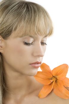 fresh and beautiful portrait of a blond woman with an orange lily