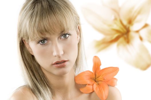 blond and young beautiful woman with an orange flower on her shoulder