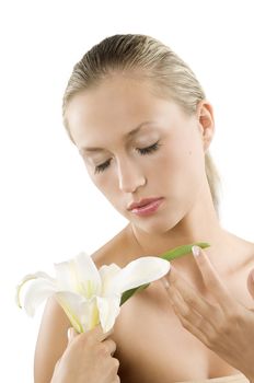 young blond woman smelling with her eyes closed a white flower